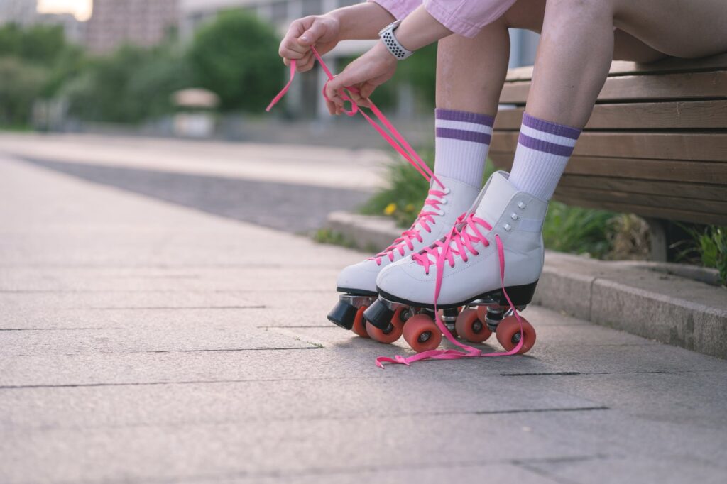 tying of shoelace on a roller skate