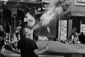 man showing trick with fire on street